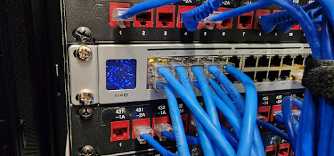 Professional patch panel and switch installation with organized CAT6/5 cabling for easy network management